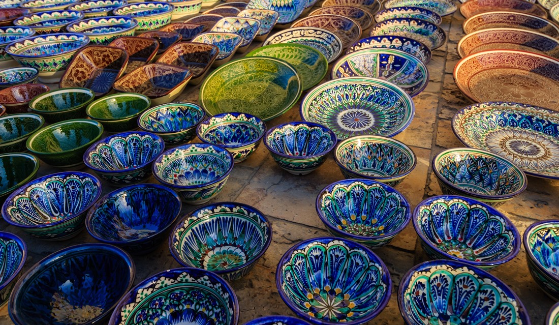 Bright hand-painted decorative plates for sale at Bukhara Bazaar