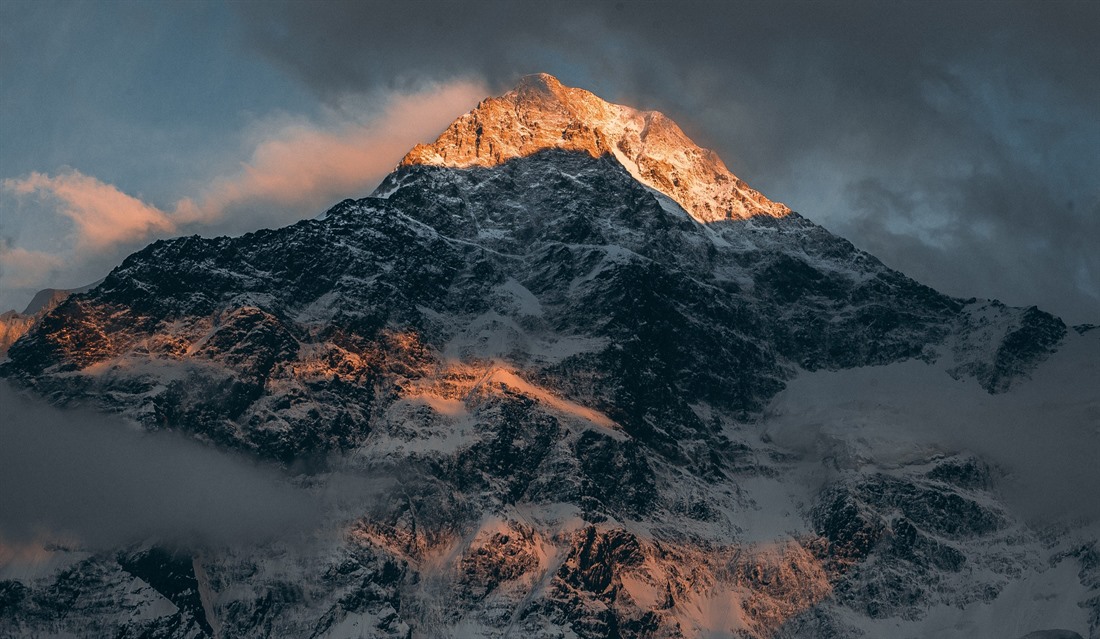The sun lights up the mountain range near Almaty. © Shutterstock/AlexandrKuznetsov
