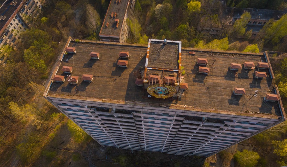 Spring - ruins of communal flats with a Soviet symbol