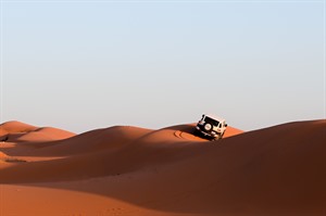 Off-road safari trip at the dunes in the red sand desert in Saudi Arab